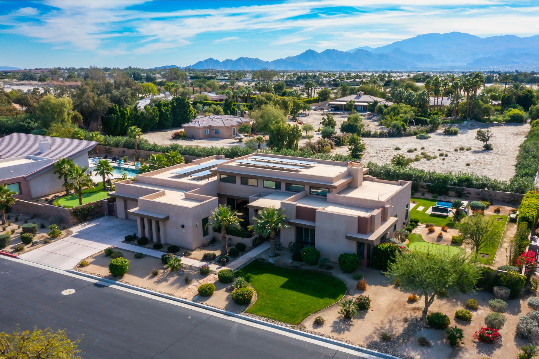 A desert home with landscaping and mountain views